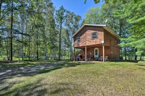 a cabin in the woods with a large yard at Atlanta Waterfront Cabin with Dock and Kayaks! 