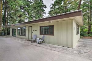 a small green and white building with two chairs at Coos Bay Retreat Less Than 2 Mi to Marina and Casino! in Coos Bay