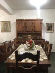 a dining room with a table with flowers on it at Pé na areia in Ilha Comprida