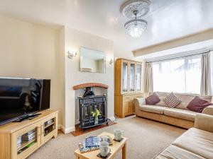 a living room with a couch and a fire place at Dunromin in Llandudno