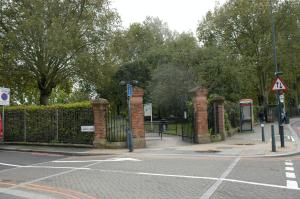 an empty street with a fence and a phone booth at 2 bedrooms apartement with wifi at Greater London in London