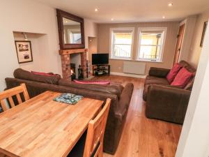 a living room with a couch and a table at Grimes Nook in Staithes