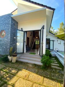a house with a staircase leading to the entrance at Summer Pool 2 Bedrooms Villa in Phu Quoc