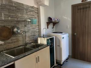 a kitchen with a sink and a dishwasher at Summer Pool 2 Bedrooms Villa in Phú Quốc