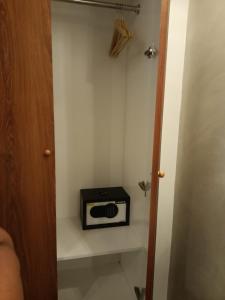 a small room with a toaster on a wall at The Kd Suites & Coffee Shop in Munggu