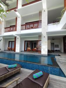 a villa with a swimming pool and a resort at The Kd Suites & Coffee Shop in Munggu