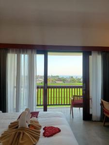a hotel room with a view of a balcony at The Kd Suites & Coffee Shop in Munggu