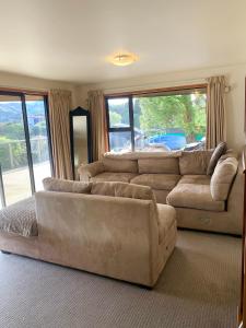 a living room with two couches and a couch at Otago Peninsula Paradise in Dunedin