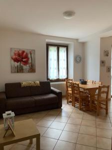 a living room with a couch and a table at Appartamenti Sole e Lago in Gravedona