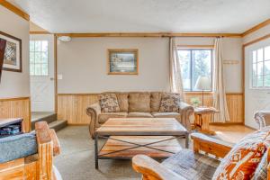 a living room with a couch and a table at Little Trail Lodge - Unit B in Government Camp