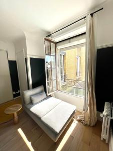 a room with a bed in front of a window at Hyper centre idéal gare Amiens in Amiens