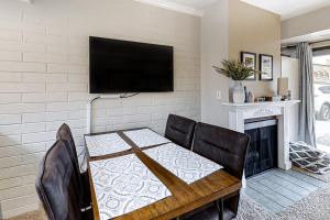 a dining room with a table and a television on a wall at New Claim Condominiums 114 in Park City