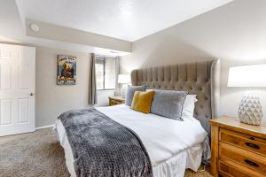 a bedroom with a large bed and a lamp at New Claim Condominiums 114 in Park City