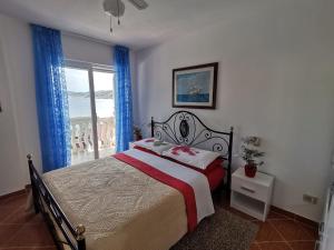 a bedroom with a large bed and a window at Apartments by the sea Cove Mikulina Luka, Korcula - 9181 in Vela Luka