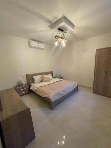 a bedroom with a bed and a ceiling fan at منتجع شرفا السياحي البيئي in Hail