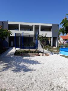 a large building with a basketball hoop in front of it at Apartments with a parking space Stinjan, Pula - 14106 in Pula