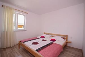 a bedroom with a bed in a room with a window at Apartments with a parking space Stinjan, Pula - 14106 in Pula