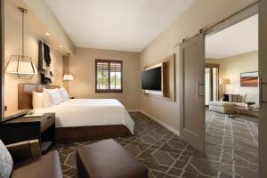 a hotel room with a bed and a television at Fairmont Scottsdale Princess in Scottsdale