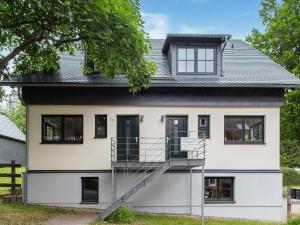 a house with a staircase in front of it at Forest Escape with Terrace in Eisfeld