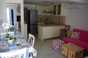 a kitchen and a living room with a table and a couch at Apartments by the sea Slatine, Ciovo - 14158 in Slatine