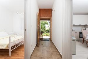 a hallway leading to a bedroom with a bed at Apartments with a parking space Icici, Opatija - 14155 in Ičići
