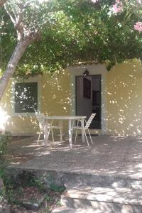 a table and chairs in front of a building at Apartments by the sea Cove Pogana, Cres - 14172 in Nerezine