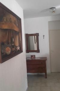 a bathroom with a mirror and a wooden dresser and a painting at Apartments by the sea Cove Pogana, Cres - 14172 in Nerezine