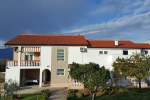 a large white house with a red roof at Apartments with parking space Vrsi, Zadar - 14211 in Vrsi