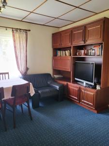 a living room with a couch and a tv at Białowieża 131 in Białowieża