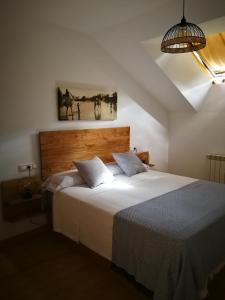 ein Schlafzimmer mit einem Bett und einem Wandgemälde in der Unterkunft Ático O Rial in Puentecesures