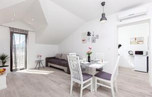 a white living room with a table and a couch at Apartments with a parking space Solin, Split - 14251 in Solin
