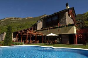 a house with a swimming pool in front of it at Hotel Riberies & Spa by RdA Hotels in Llavorsí