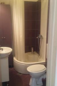 a bathroom with a toilet and a shower and a sink at Apartments with parking space Marina, Trogir - 14258 in Marina +24 photos
