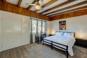 a bedroom with a bed and a window and a door at Pine Tree Place - Unit 1 in South Lake Tahoe