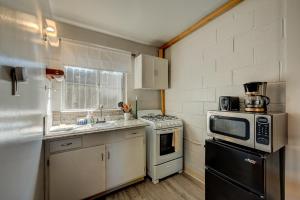 a kitchen with a stove and a microwave at Pine Tree Place - Unit 1 in South Lake Tahoe