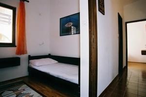 a small bedroom with a bed in a room at Seaside holiday house Ist - 14366 in Ist