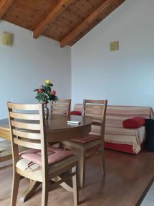 a dining room with a table and chairs and a bed at Apartments with a parking space Savar, Dugi otok - 14373 in Savar