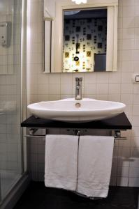 a bathroom with a sink and a mirror and towels at Locanda degli Antiquari in Rome +46 photos