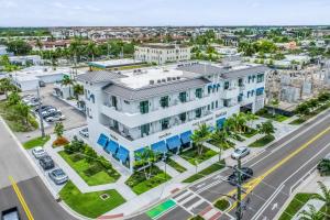 an aerial view of a white building with a street at SoCe Flats 209 in Naples