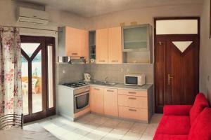 a kitchen with a red couch in a room at Apartments by the sea Povlja, Brac - 14399 in Povlja