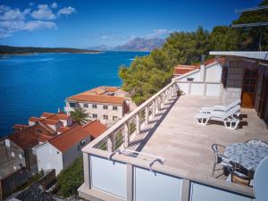 a balcony with a view of the water at Apartments by the sea Povlja, Brac - 14399 in Povlja