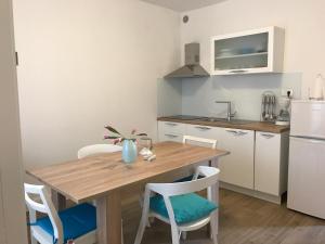 a small kitchen with a wooden table and chairs at Apartments by the sea Stupin Celine, Rogoznica - 14416 in Podglavica