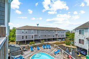 an aerial view of a building with a pool and chairs at 5280 Waves in Corolla