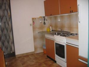 a small kitchen with a stove and a sink at Apartment Krk 14484b in Krk