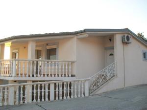a white house with a balcony with a balcony at Apartments with a parking space Starigrad, Paklenica - 14507 in Starigrad-Paklenica +13 photos