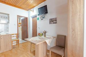 a dining room with a table and a tv on the wall at Apartments by the sea Cove Vela Stiniva, Hvar - 14511 in Zastražišće