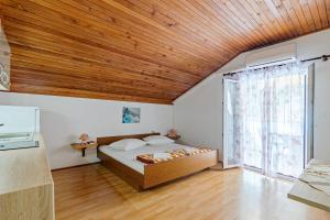 a bedroom with a bed and a large window at Apartments by the sea Cove Vela Stiniva, Hvar - 14511 in Zastražišće