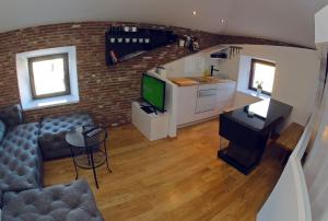 a living room with a couch and a tv and a kitchen at Apartments with WiFi Zadar - 14529 in Zadar +8 photos