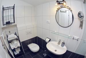 a bathroom with a sink and a toilet and a mirror at Apartments with WiFi Zadar - 14529 in Zadar