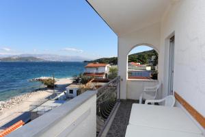 a balcony with a view of the ocean at Apartments by the sea Slatine, Ciovo - 14541 in Slatine